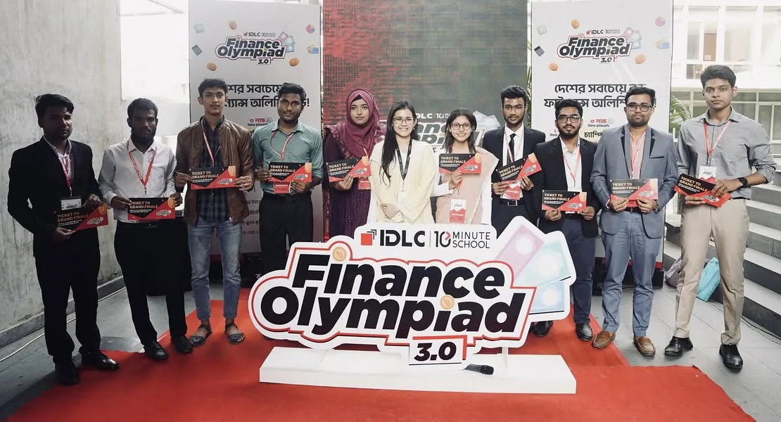 The top ten finalists standing behind a giant Finance Olympiad 3.0 logo standee