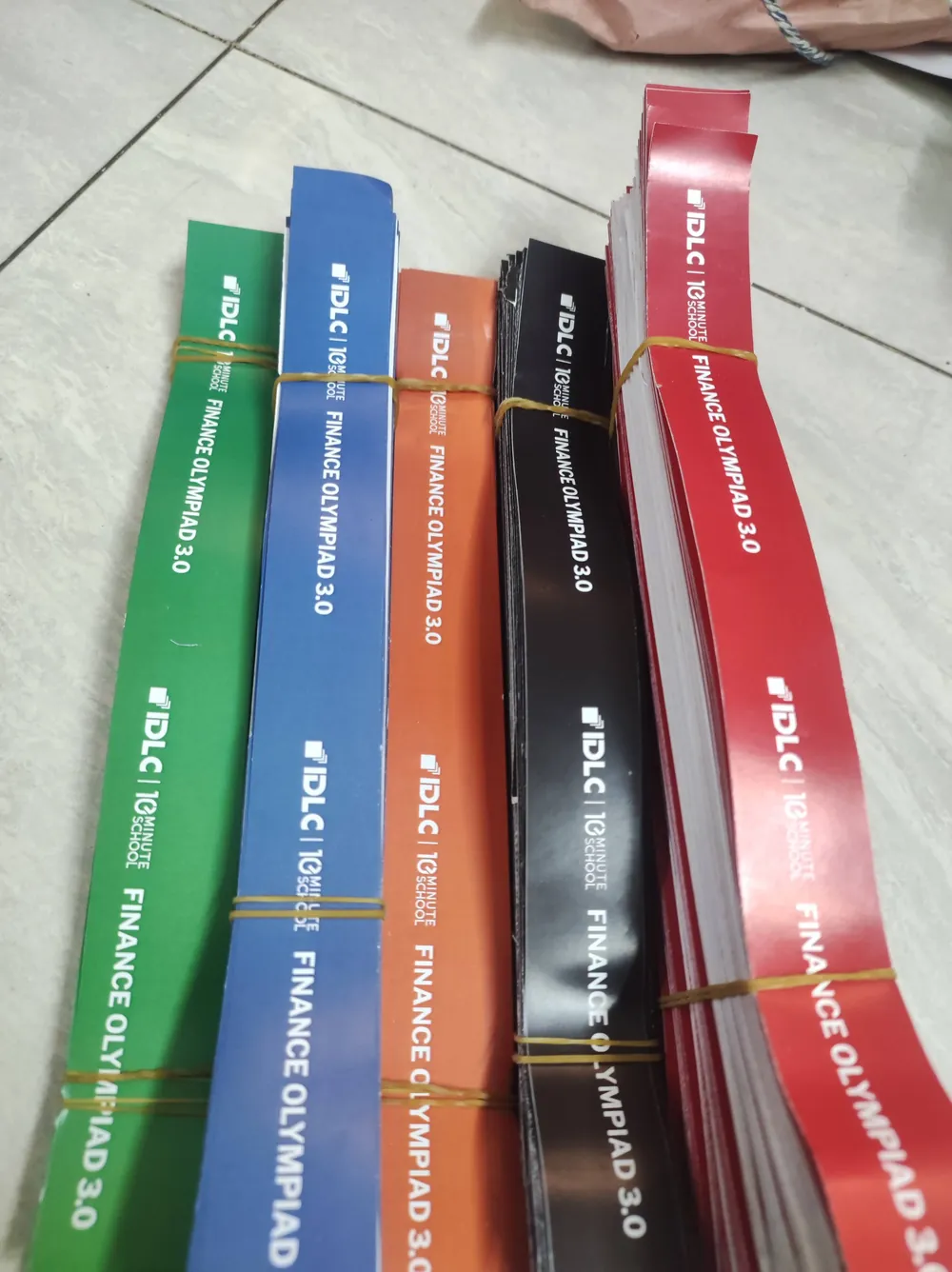 Lanyards in green, blue, orange, black and red, bundled