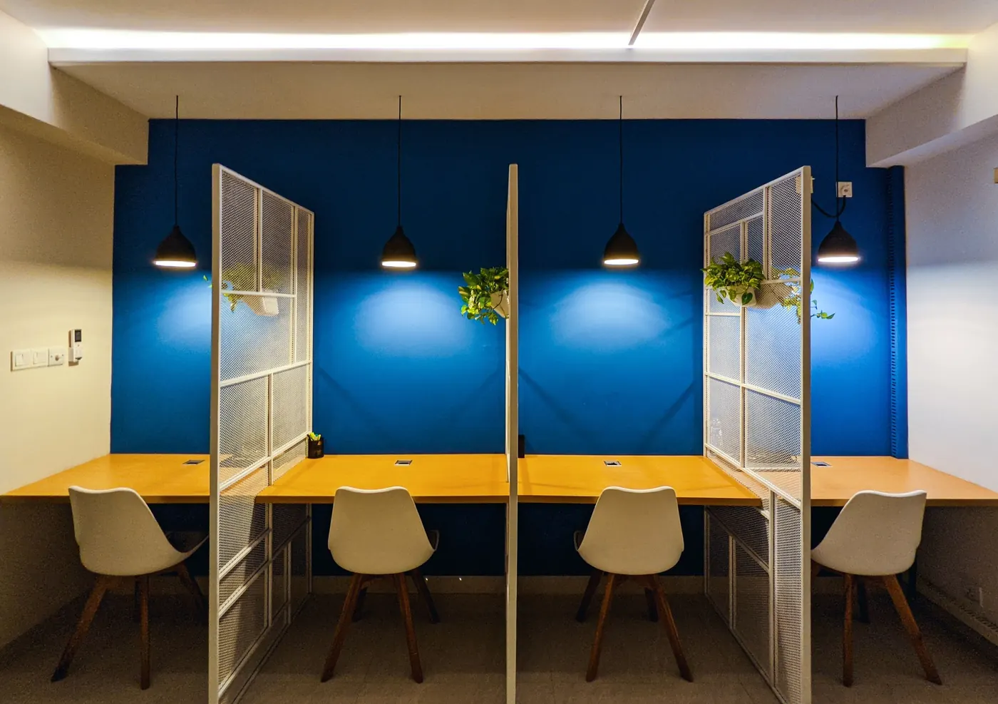 Focus booths against a deep blue wall