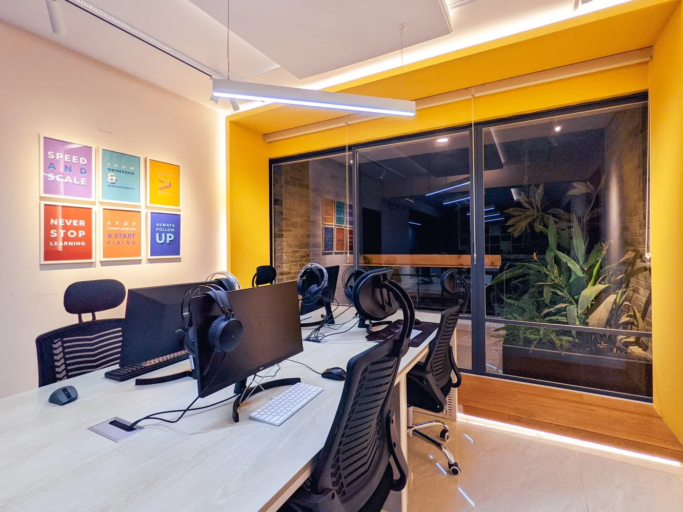 Desks in a bright yellow corner