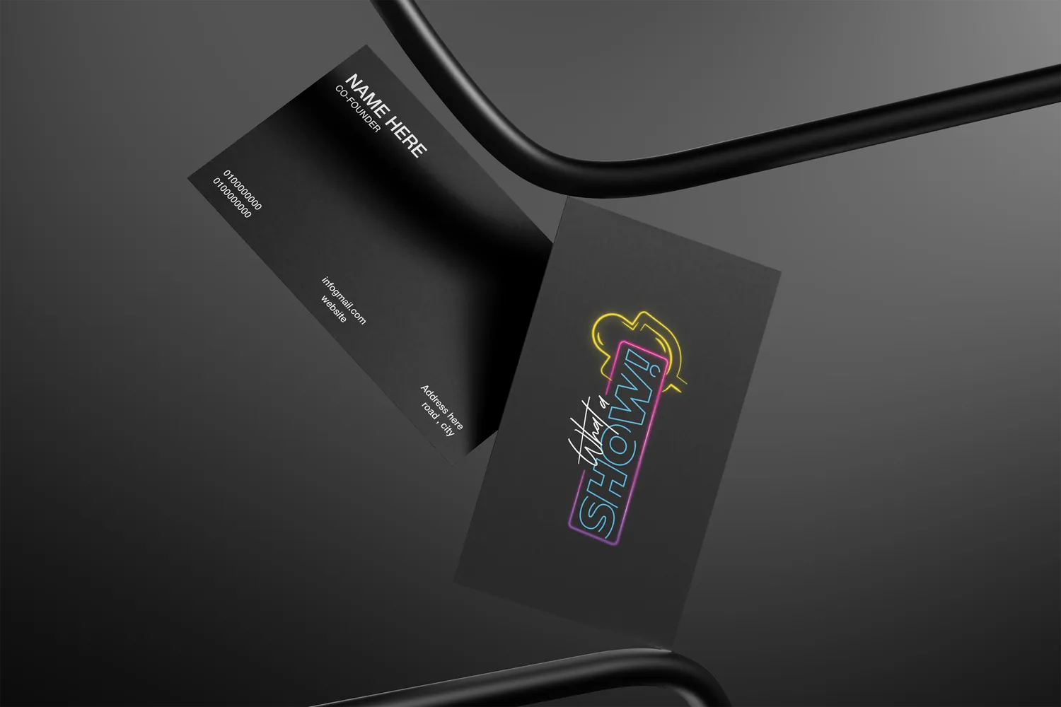 Business cards in black with the neon sign