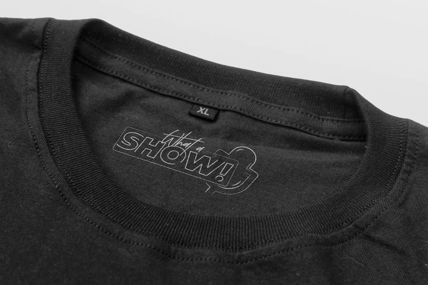A black tee with the sign printed on the neck label